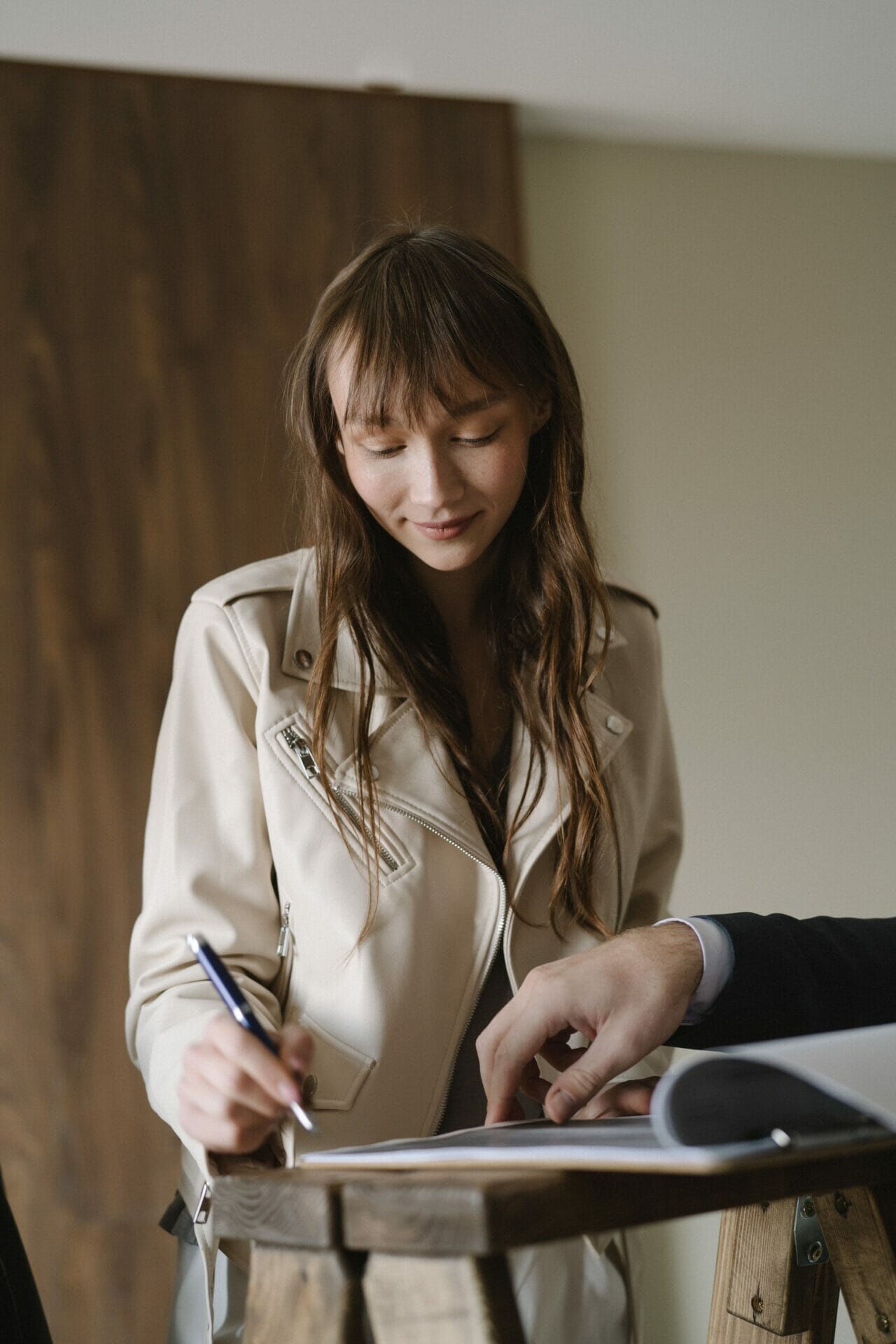 a woman signing a property contract of sale
